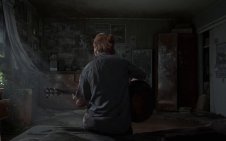 Ellie playing guitar in the room