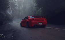 Red Nissan parked on the road