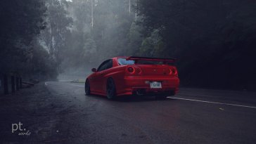 red nissan parked on the road live wallpaper